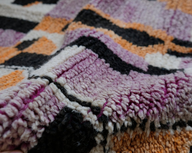 Umgeschlagener Rand: weicher Flor in Lila, Schwarz und Orange